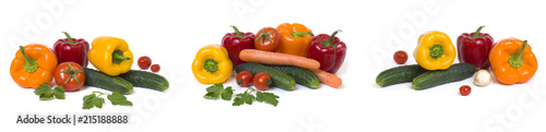Panoramic view of the red yellow and orange peppers with tomatoes on a white background..Cucumbers with colorful peppers in composition on a white background.