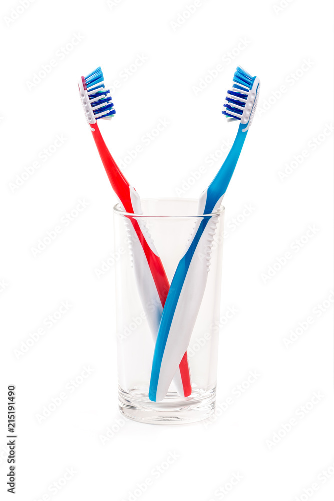 Two toothbrushes in glass isolated on white background Two toothbrushes in glass isolated on white background