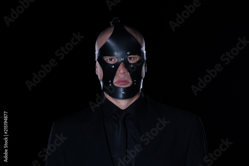 Fototapeta Naklejka Na Ścianę i Meble -  a man in a black mask on a black background