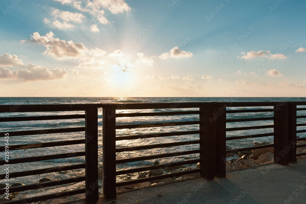  fence against the sea at sunset