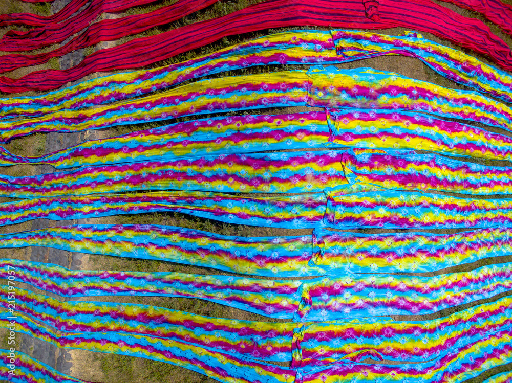 Colorful fabric hanging to dry after traditional process Brid eye view, in Mojolaban 