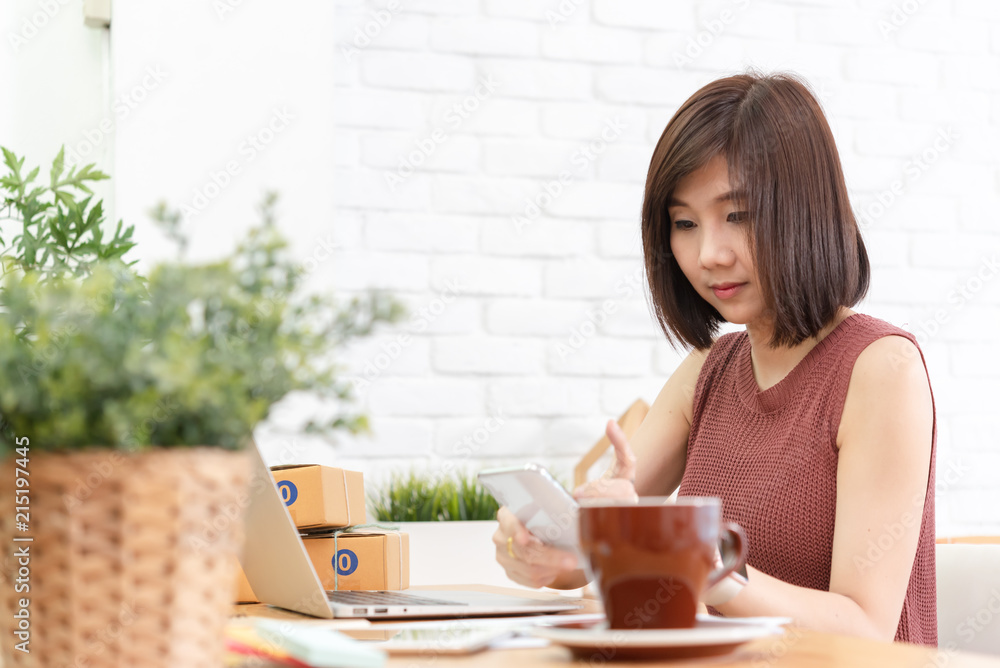 Woman small business owner, business start up conceptual, young entrepreneur work with laptop sell product online shop Woman small business owner, business start up conceptual, young entrepreneur work with laptop sell product online shop
