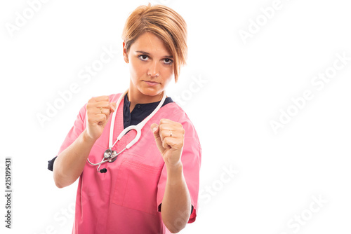 Portrait of female vet wearing pink scrub showing both fists.