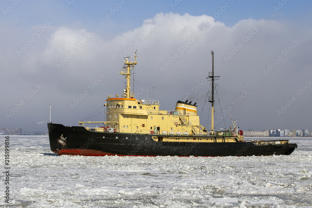 Fototapeta premium Icebreaker ship vessel in ice tries to break between the glaciers