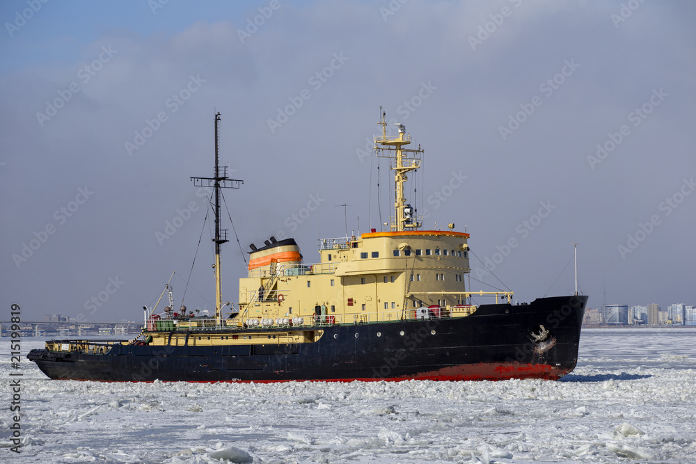 Icebreaker ship vessel in ice tries to break  between the glaciers