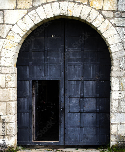 Old black metal door in a medieval castle © Maksym Kapliuk