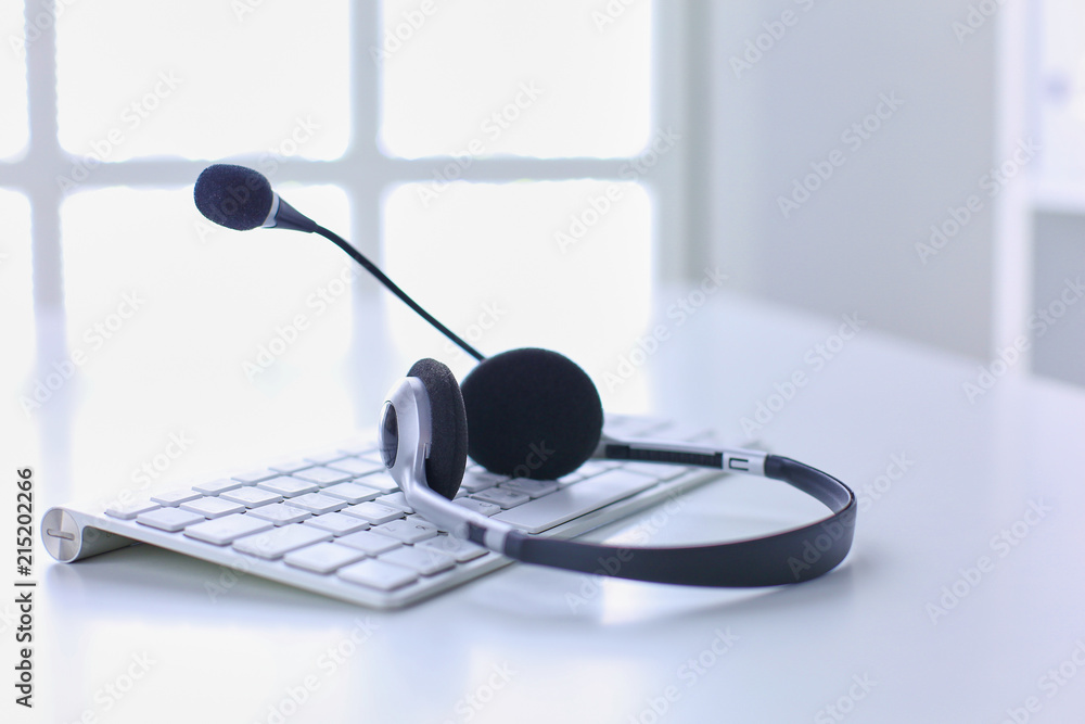 Call center and customer service help desk. VOIP headset on laptop computer keyboard Call center and customer service help desk. VOIP headset on laptop computer keyboard