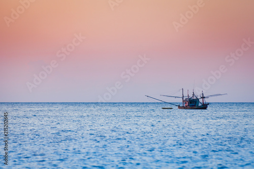 Fishing boat floating on the sea before sunset in Koh Phangan, Thailand.