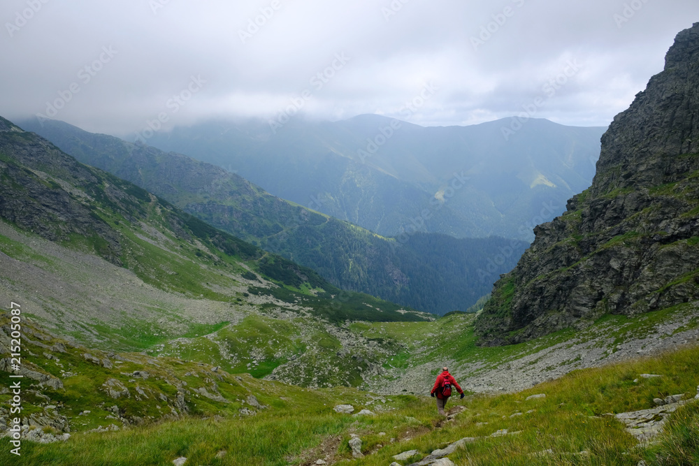 Rumunia, Karpaty Rumuńskie - Góry Fagaras, turysta w czerwonej kurtce na szlaku w Górach Paltinu