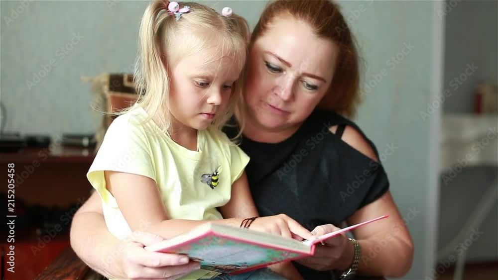 Girl and mom reading a book
