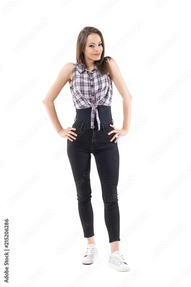 Beautiful young woman fashion model in funky style clothes posing with arms on hips. Full body isolated on white background. Beautiful young woman fashion model in funky style clothes posing with arms on hips. Full body isolated on white background.