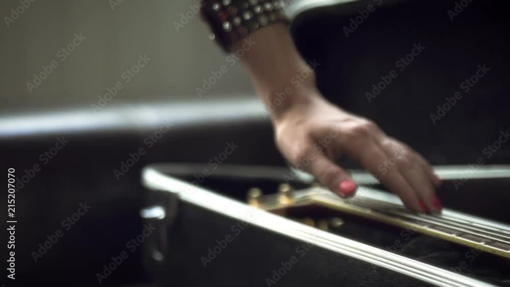 The girl takes out the guitar from the case The girl takes out the guitar from the case