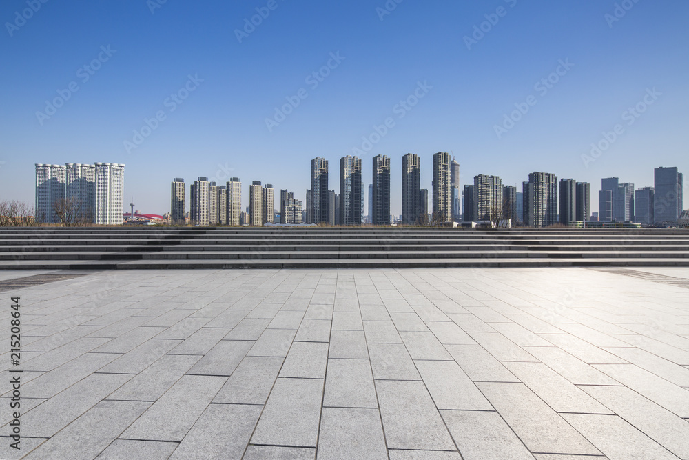 Panoramic skyline and modern business office buildings with empty road,empty concrete square floor Panoramic skyline and modern business office buildings with empty road,empty concrete square floor