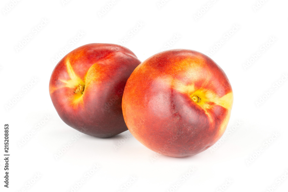 Group of two whole ripe deep red nectarine isolated on white