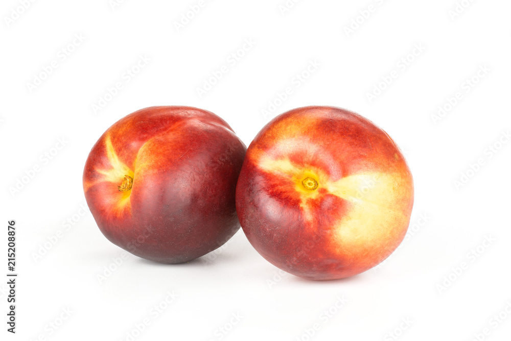 Group of two whole ripe deep red nectarine isolated on white Group of two whole ripe deep red nectarine isolated on white