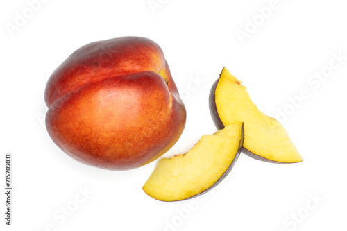 Group of one whole two slices of ripe deep red nectarine flatlay isolated on white
