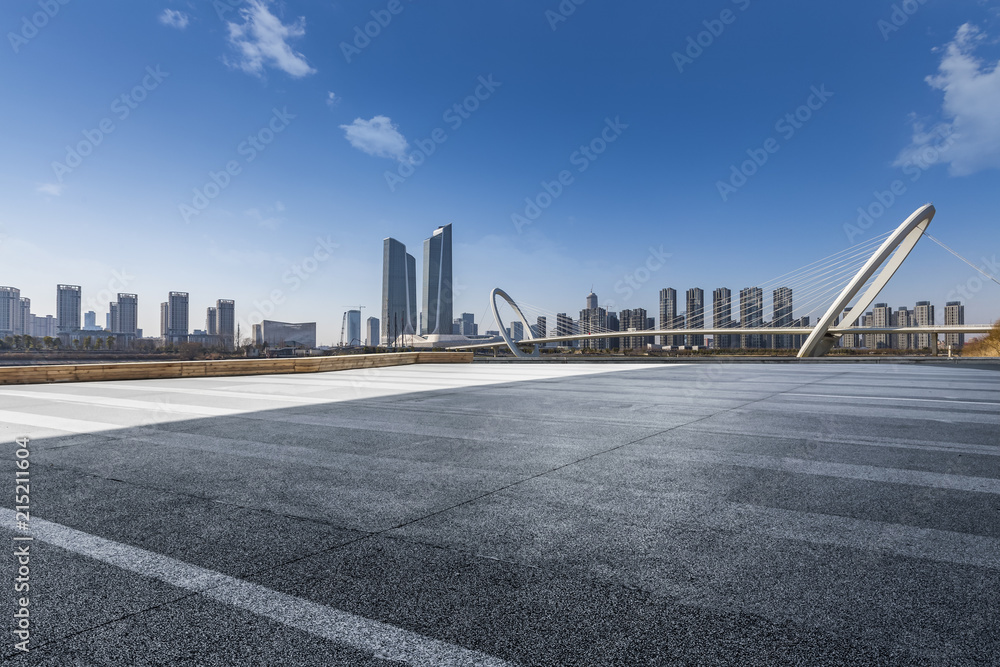 Obraz premium Panoramic skyline and modern business office buildings with empty road,empty concrete square floor