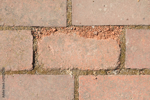 Broken tile in the pavement photo