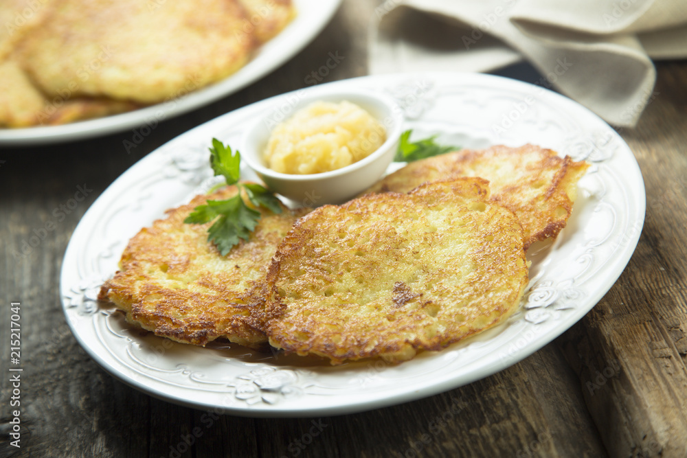 Potato pancakes, or latkes with apple sauce Potato pancakes, or latkes with apple sauce