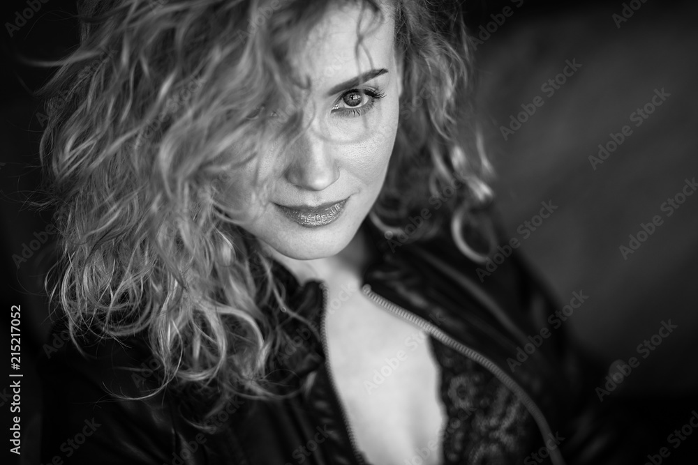 Close-up portrait of sexy blonde woman in a black leather jacket and lacy bra, fashion beauty photo