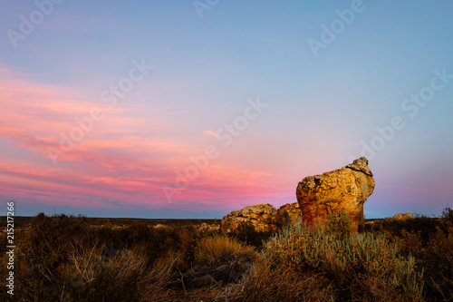 Interesting rock formations at sunrise with pink clouds in the sky