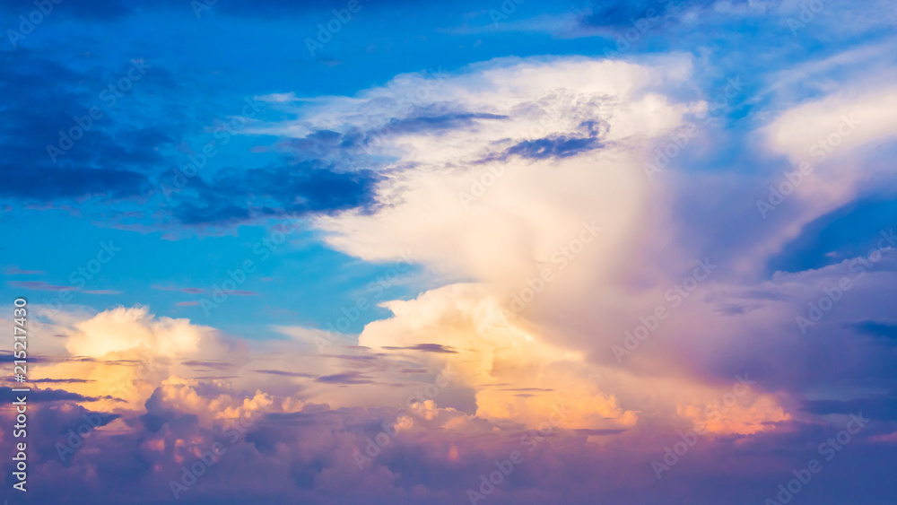 Colorful clouds in the blue sky during the sunrise; background, pattern for design_