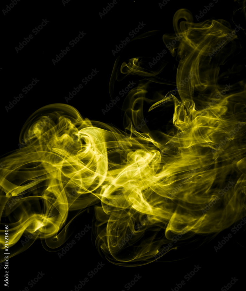 Fototapeta premium Yellow smoke on black background