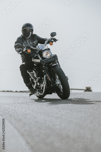 Close up of motorcycle turning on the road asphalt.