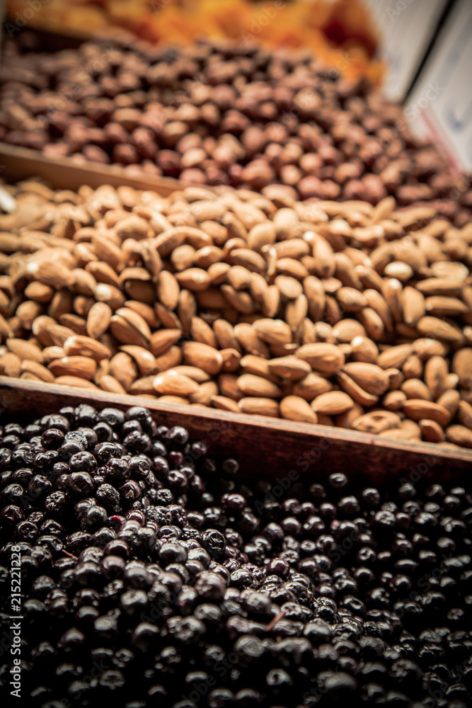 Almonds and dried aronia berries on farmer’s market / Heap of dried fruit on marketplace Almonds and dried aronia berries on farmer’s market / Heap of dried fruit on marketplace