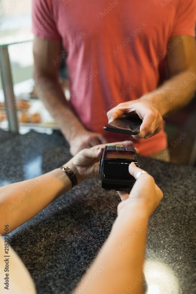 Customer making payment through mobile phone Customer making payment through mobile phone