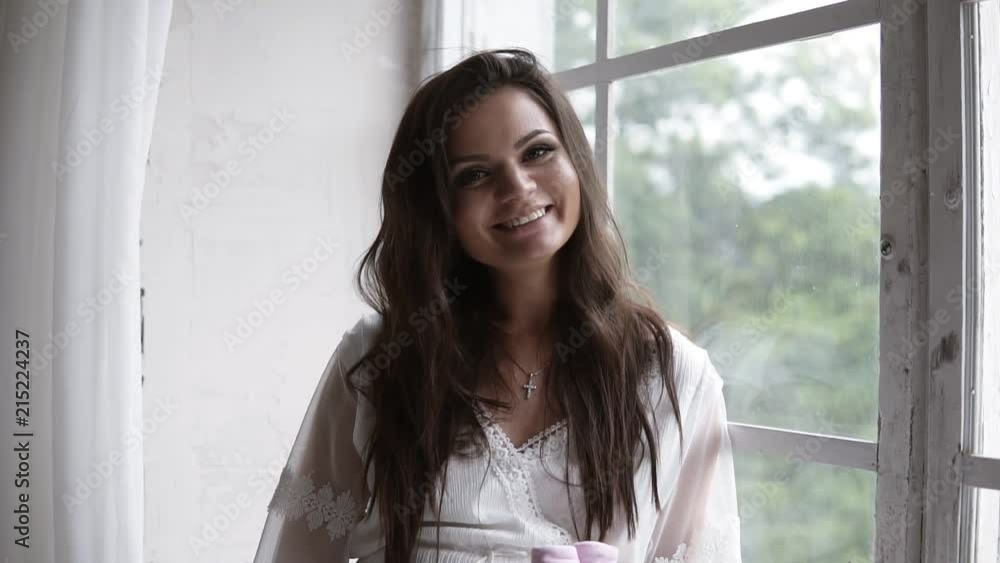 Portrait of the young pregnant woman. Pregnancy, love, people and expectation concept. Happy pregnant lady with long hair holding little booties