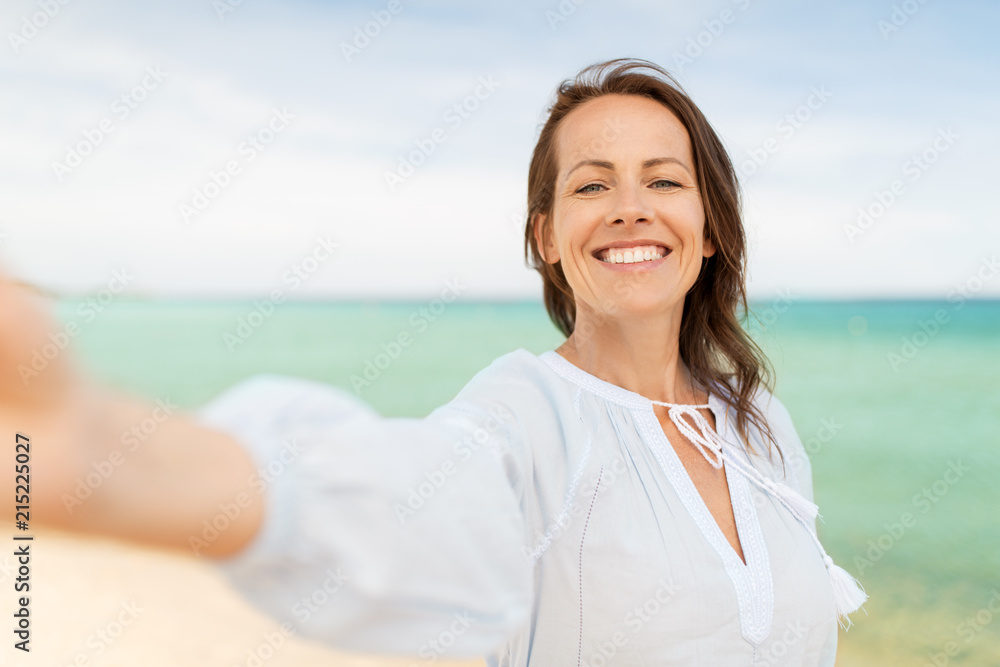 summer holidays and leisure concept - happy smiling woman taking selfie on beach summer holidays and leisure concept - happy smiling woman taking selfie on beach