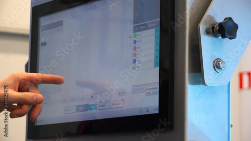 Male hand makes adjustments on computer display.