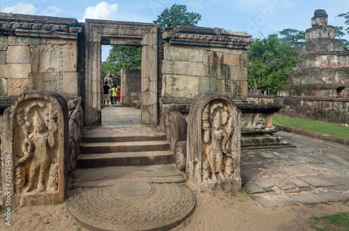 Family of tourists watching around ruined city with the 12th century brick buddhist temple, Sri Lanka. Ancient town Polonnaruwa. UNESCO World heritage Site photo