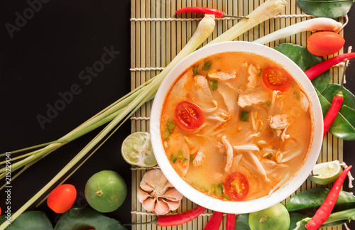 Tom Yum Gai or spicy tom yum soup with chicken - Authentic Thai style food. With ingredients: lemongrass, galangal, kaffir lime leaves, fresh chilies, and lime.