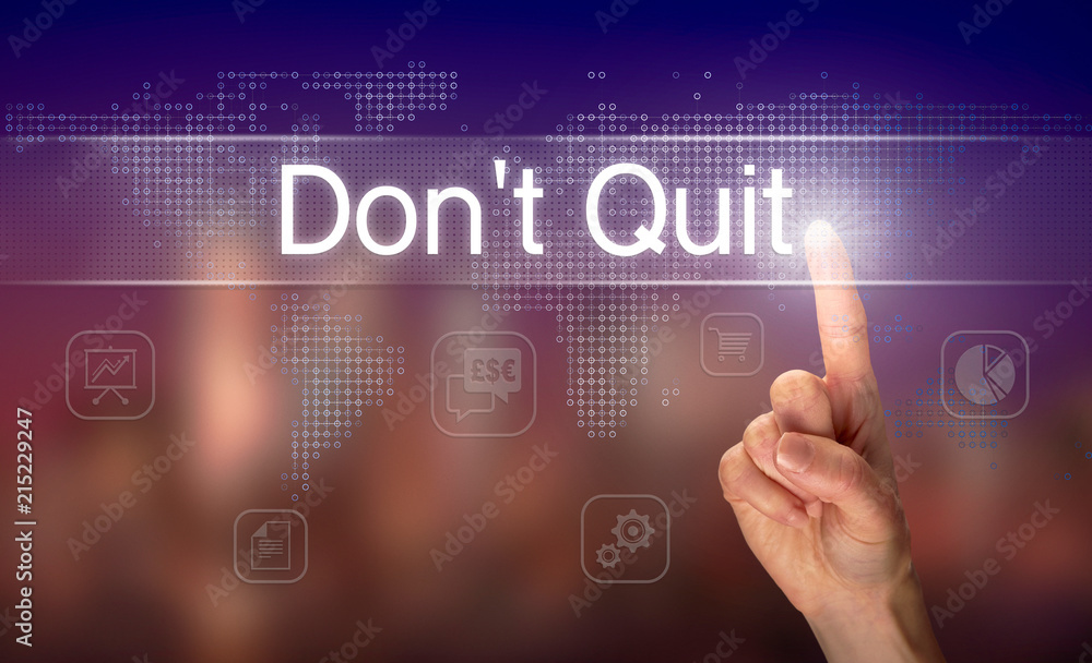 A hand selecting a Don't Quit business concept on a clear screen with a colorful blurred background.