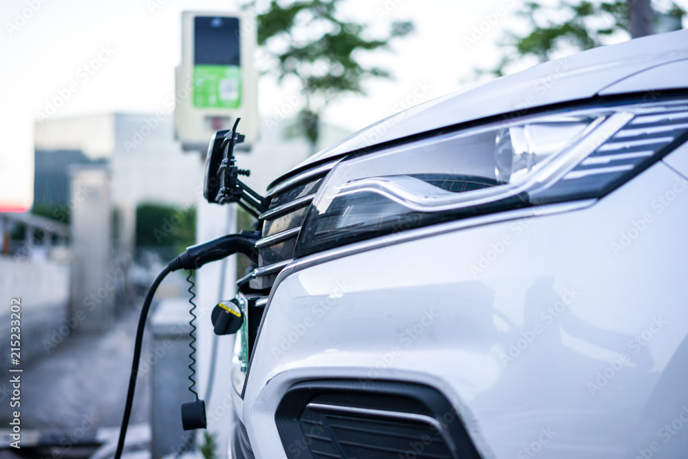 Fototapeta premium electric car charging in station