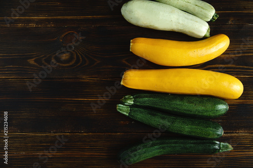 Autumnal harvest squash and zucchini variety on wooden background. Top view with copy space