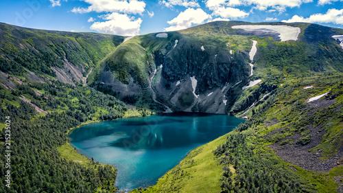 Fototapeta Naklejka Na Ścianę i Meble -  Blue lake in the mountains green grass and snow Ivanovo lakes