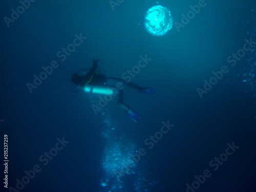 Scuba Diver in deep cold murky water with air bubbles, Galapagos, Ecuador