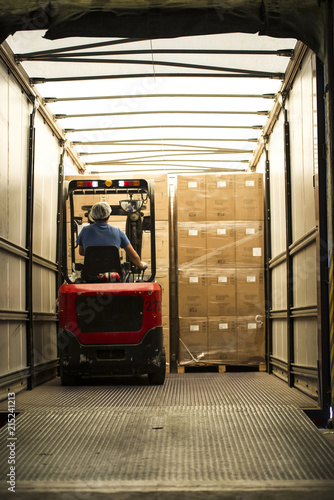 Man loading cardboard boxes in lorry photo