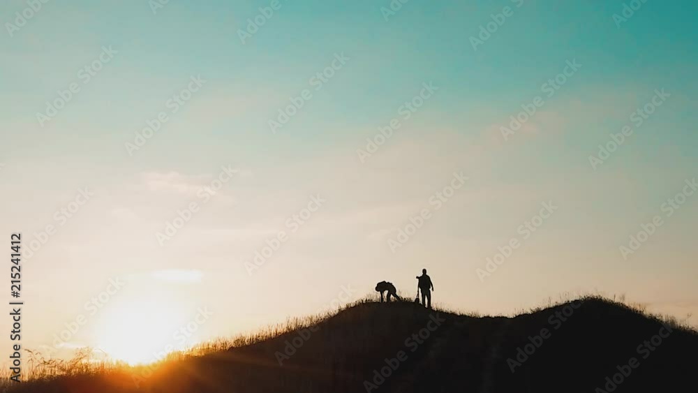 two men tourists hikers silhouette go to the mountains sunset travel slow motion video. Traveler successful young men lifestyle walking on top of Mountain and waiting for sunrise. travel tourists in two men tourists hikers silhouette go to the mountains sunset travel slow motion video. Traveler successful young men lifestyle walking on top of Mountain and waiting for sunrise. travel tourists in