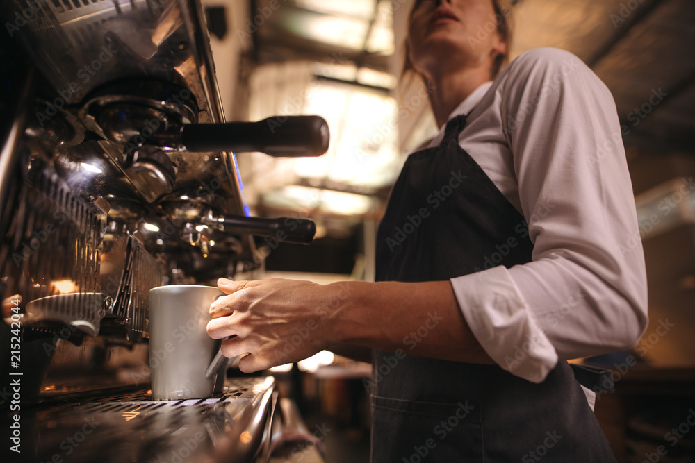 Naklejka premium Barista making coffee on coffee maker machine