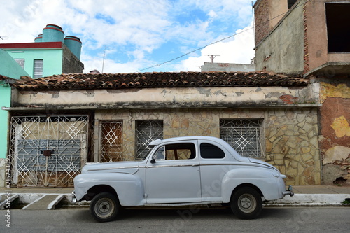 Cuban old city and 1950's classic car in Trinidad Centro Historico