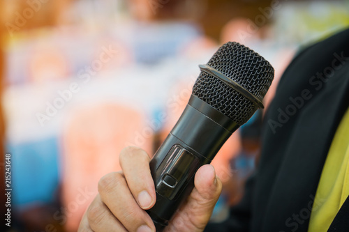 Seminar Conference Concept : hands businesspeople holding microphones for speech or speaking in seminar room, talking for lecture to audience university, Event light convention hall Background.