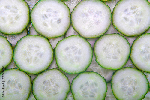 Fresh green slices of cucumber as background
