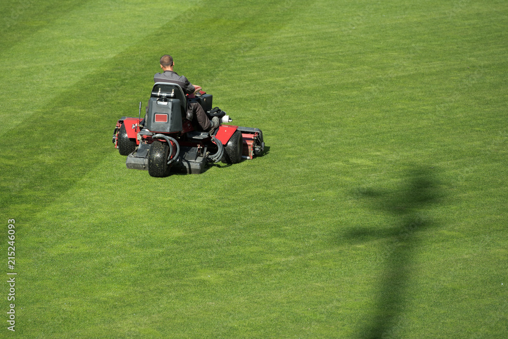 Mowing grass at the football stadium Mowing grass at the football stadium