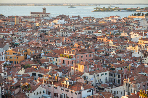 Elevated view of Venice with roofs buildings and sea before sunset, Italy