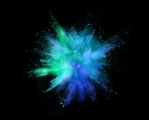 Coloured powder explosion isolated on black background