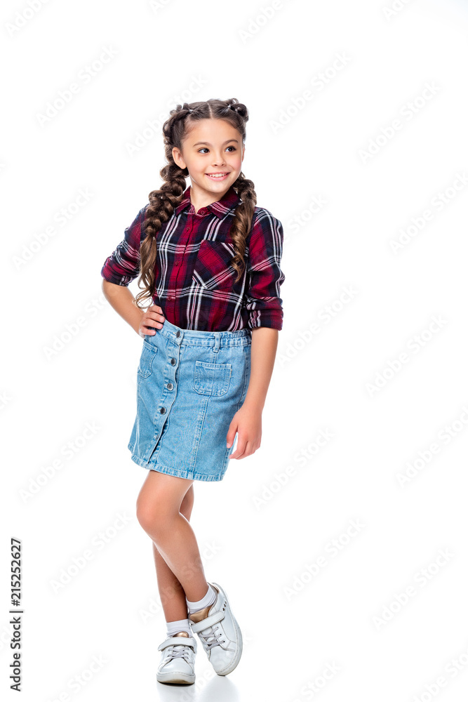 schoolchild in denim skirt and checkered shirt posing and looking away isolated on white schoolchild in denim skirt and checkered shirt posing and looking away isolated on white